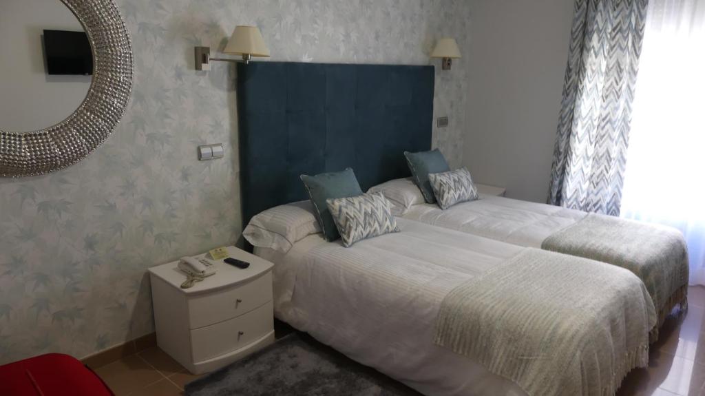 Postel nebo postele na pokoji v ubytování Hotel Las Moradas