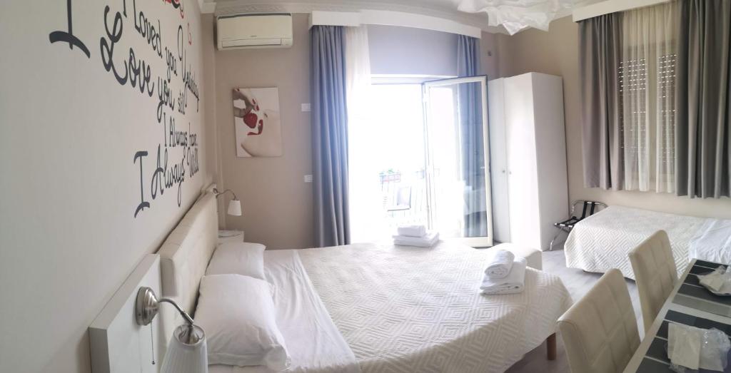 A bed or beds in a room at Athena Charming Rooms