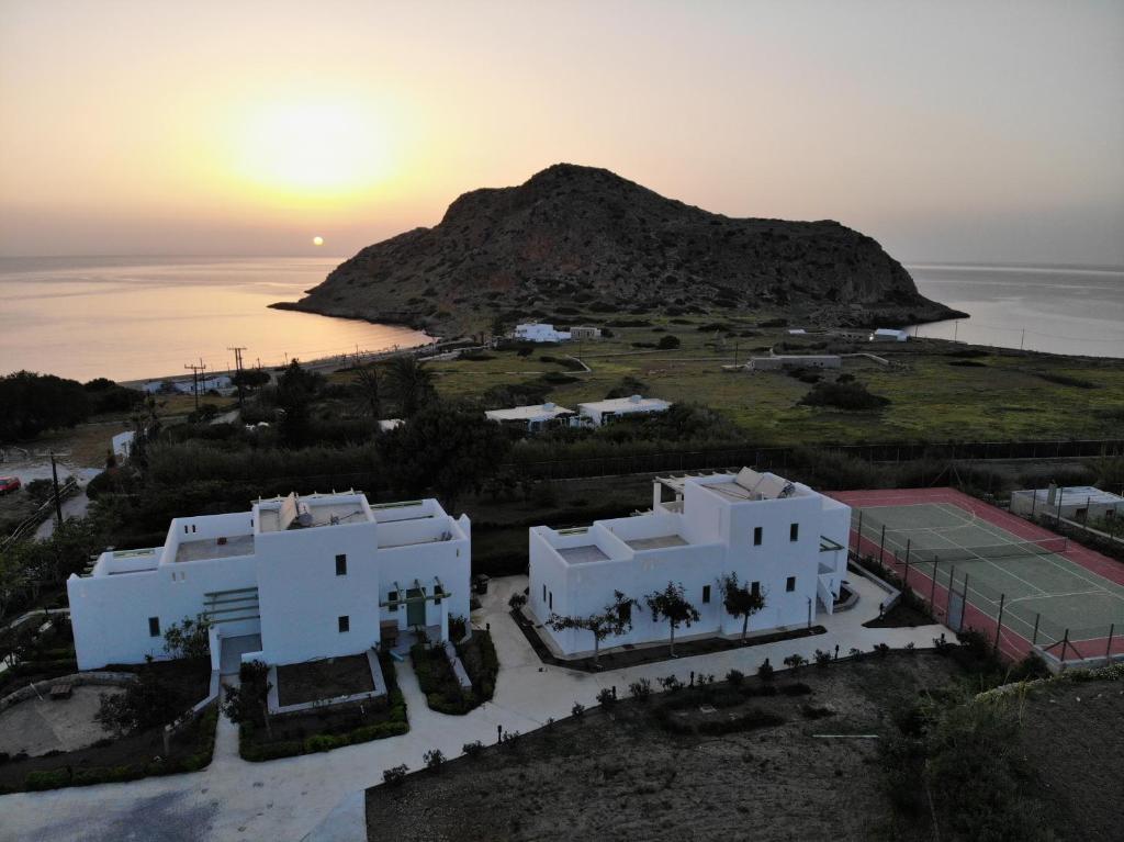 an aerial view of a villa with the sunset in the background at Alona Luxury Villas in Arkasa