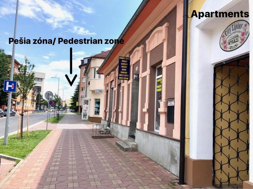 a building on the side of a street at Apartments City Liptov in Liptovský Mikuláš