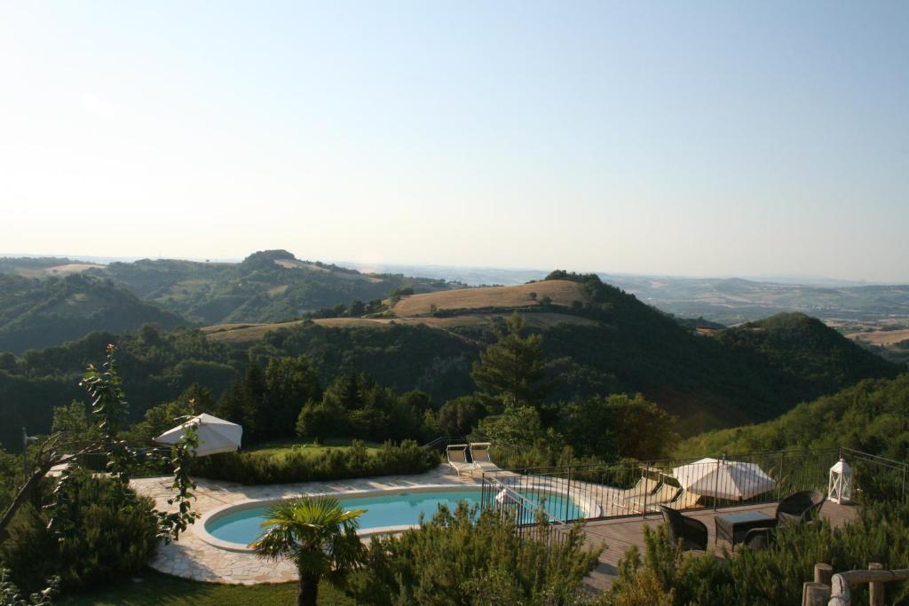 a view of a swimming pool with mountains in the background at Cornio Delle Fronde in Fontecorniale