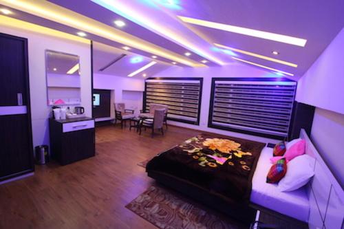 a living room with a bed and a dining room at AS Clarks inn in Dalhousie