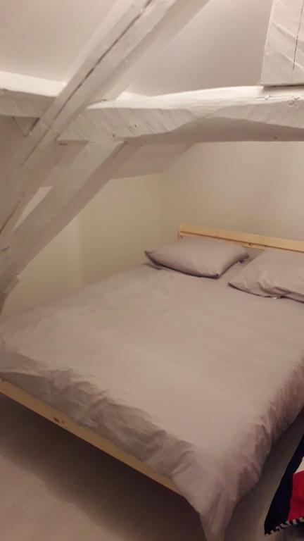 a bunk bed with two pillows on top of it at Maison en pierre totalement renovée in Marsainvilliers