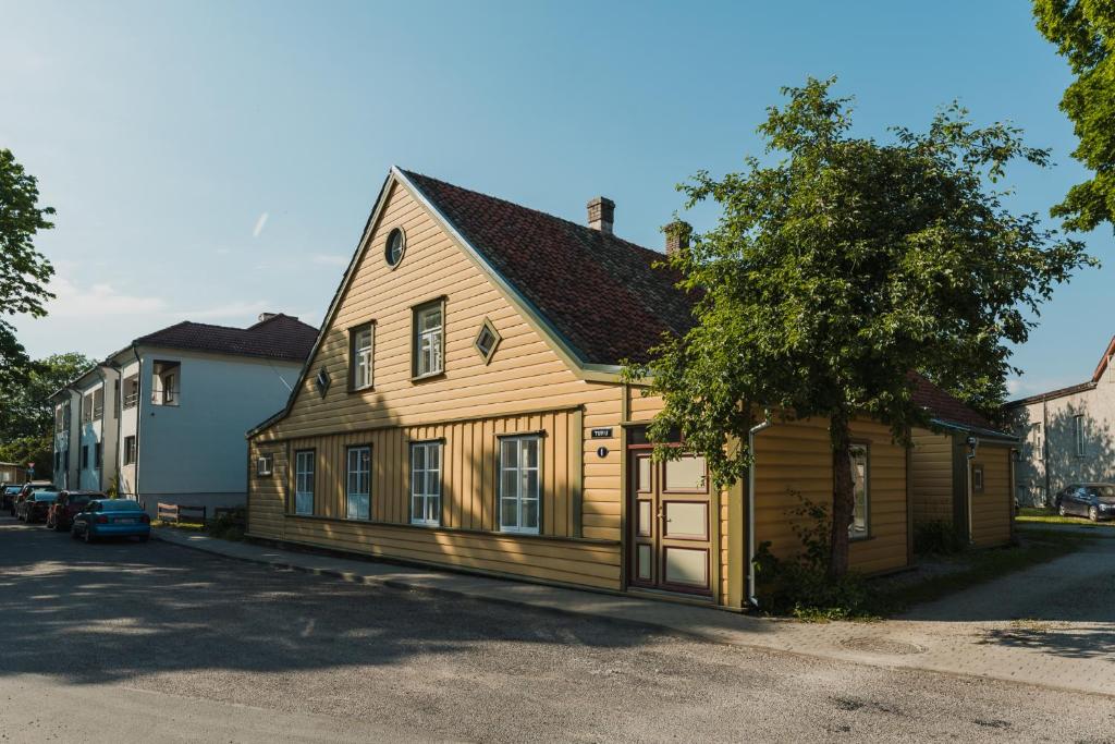 a wooden house sitting on the side of a street at Kuressaare Turu Apartment in Kuressaare