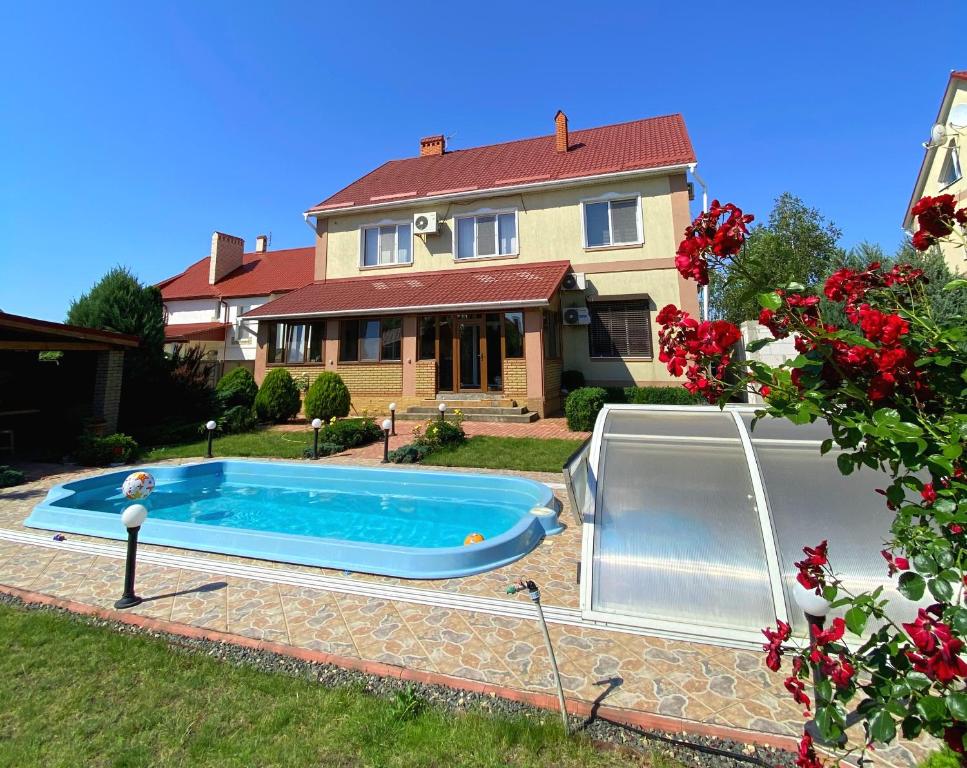a swimming pool in front of a house at Villa Costa in Sanzhiyka