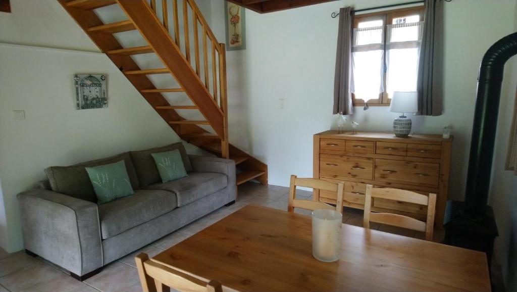 a living room with a couch and a table at Les Landes De Mauchat in Saint-Martin-de-Fressengeas