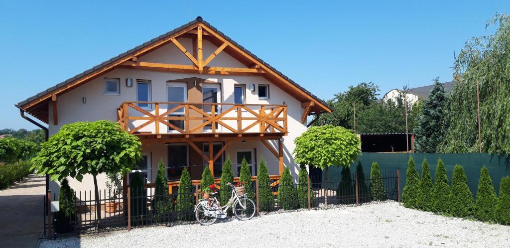 a house with a bike parked in front of it at Flower Bike in Štúrovo