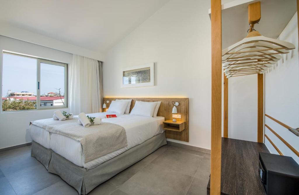 Posteľ alebo postele v izbe v ubytovaní Lotus Hotel Apartments