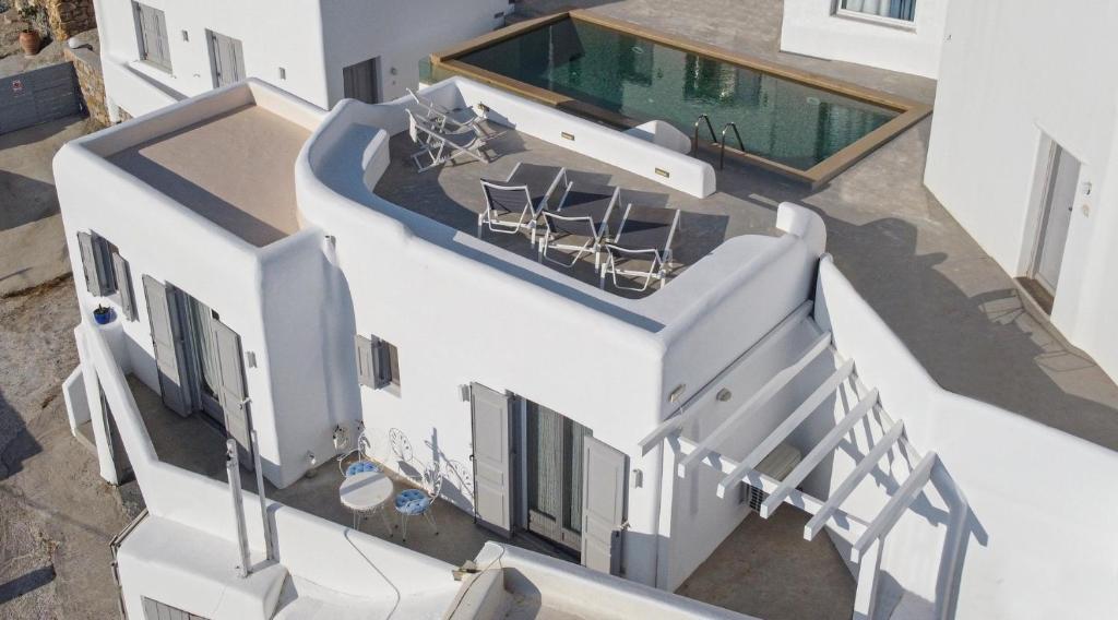 an overhead view of a house with a spiral staircase at Myconian Relax House with swimming pool in Ano Mera