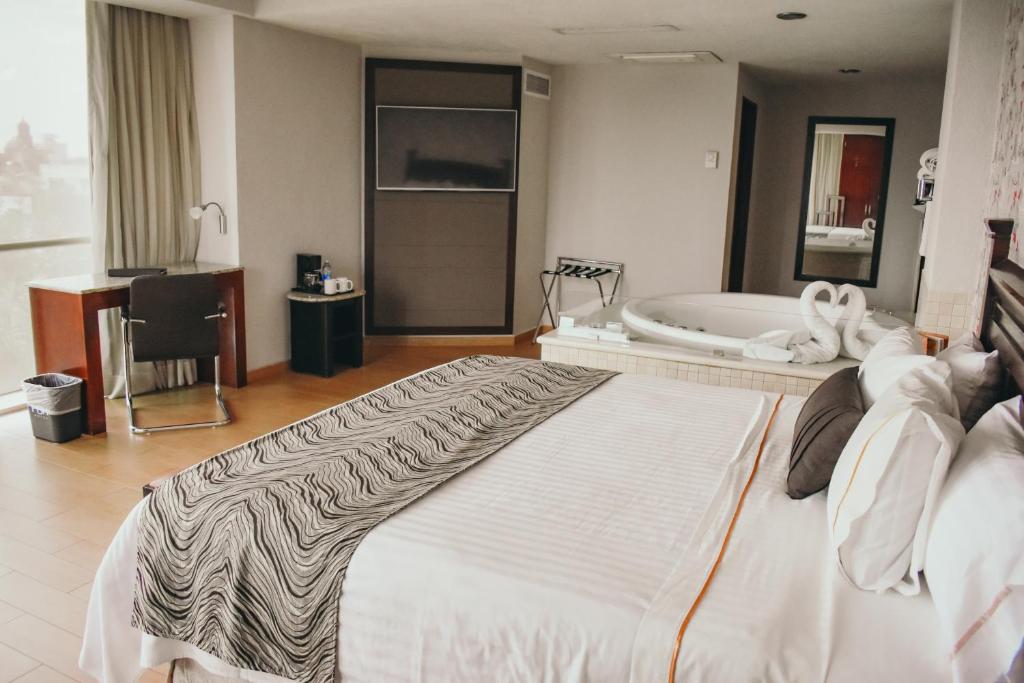 Postel nebo postele na pokoji v ubytování Hotel Portobelo