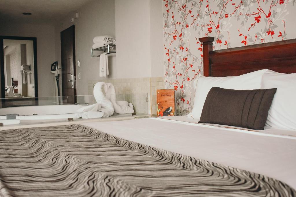 Postel nebo postele na pokoji v ubytování Hotel Portobelo
