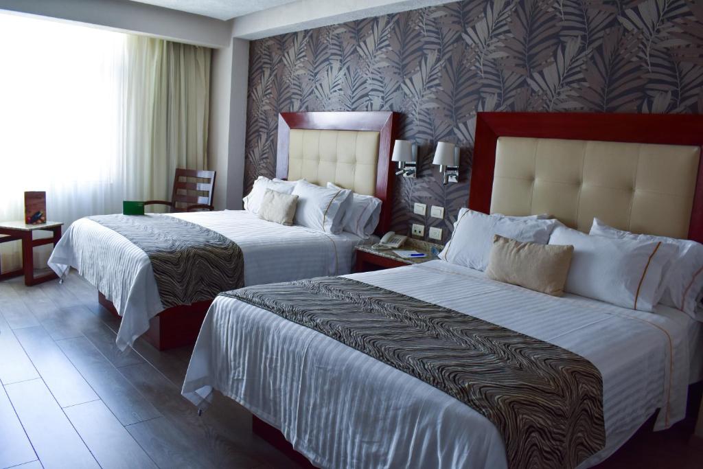 Postel nebo postele na pokoji v ubytování Hotel Portobelo