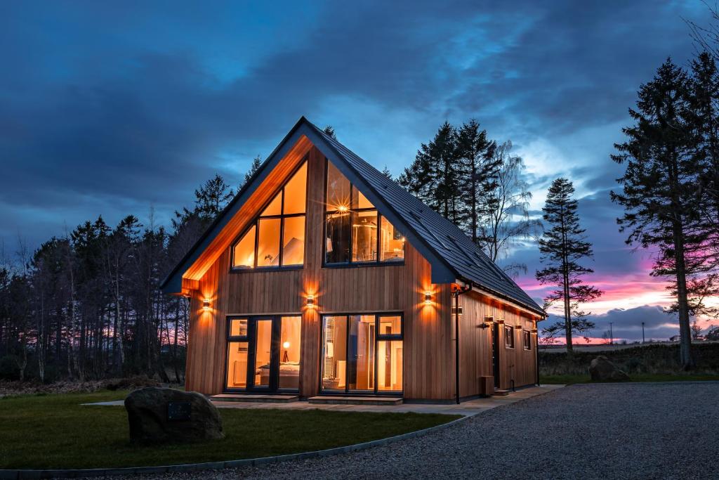 a barn style house with large glass windows at Newlands Lodges in Shotley Bridge