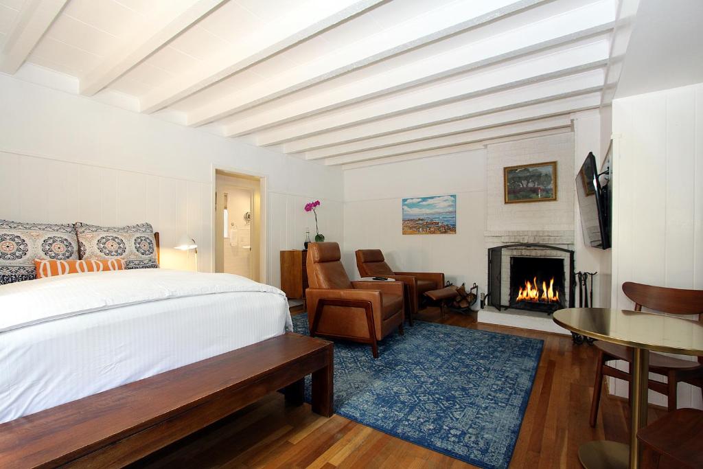 a bedroom with a bed and a fireplace at The Vagabond's House Boutique Inn & Spa Studio in Carmel