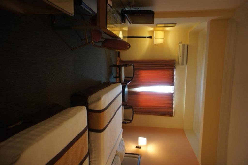 Postel nebo postele na pokoji v ubytování Tyng Garden Hotel