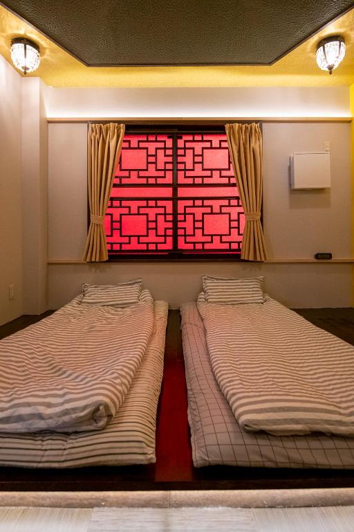 Postel nebo postele na pokoji v ubytování Room Inn Shanghai 横浜中華街 Room1-ABC