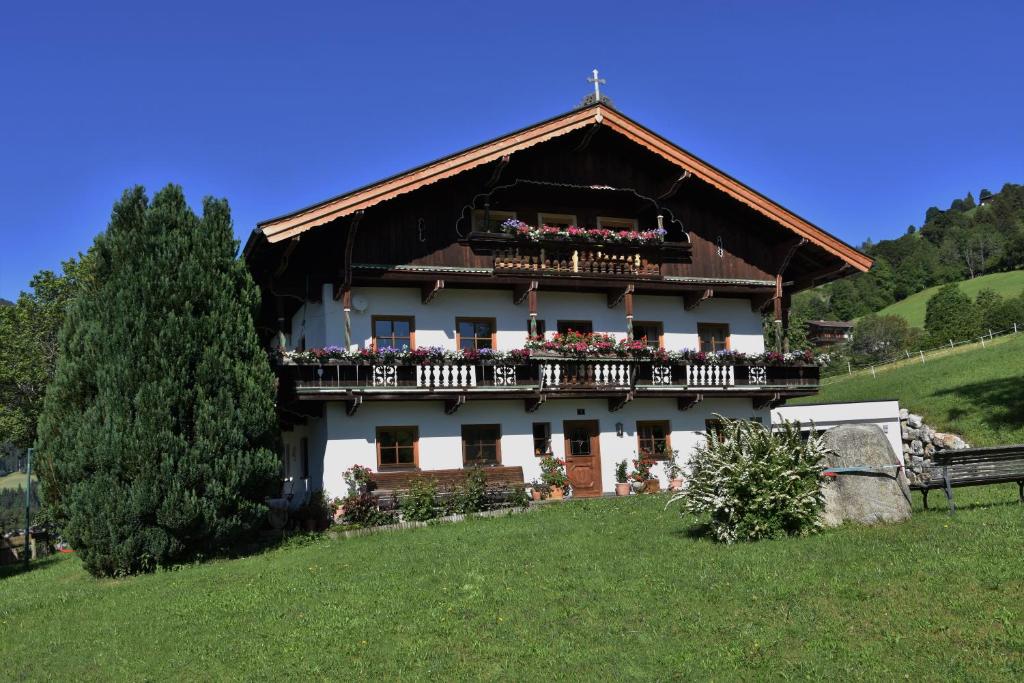 dom na wzgórzu z kwiatami na balkonie w obiekcie Fuchsbauer w mieście Hopfgarten im Brixental