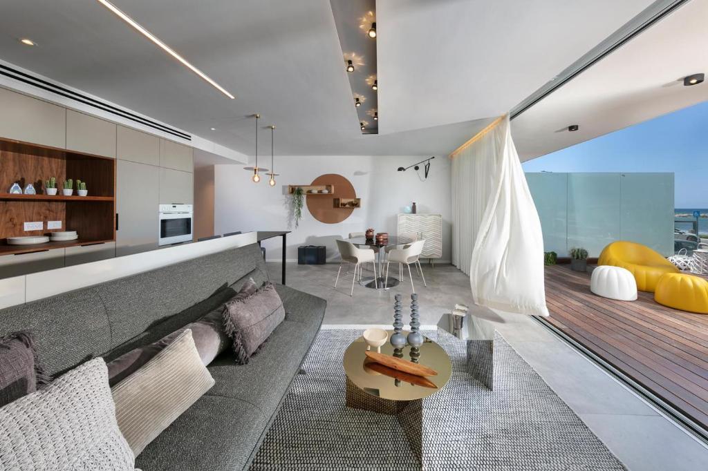 a living room with a couch and a table at Beach Lux Apartment in Haifa