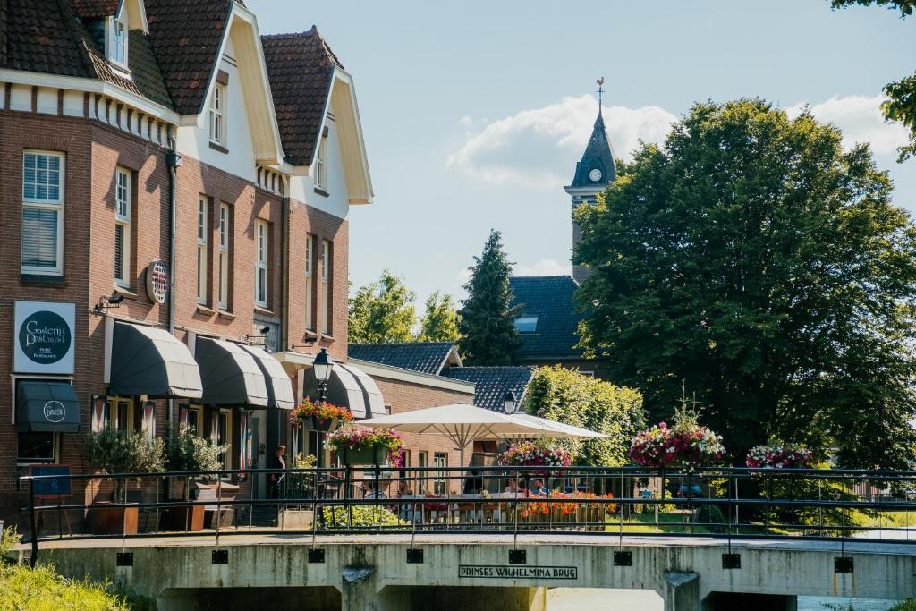 a street in a town with a clock tower at Gasterij Posthuys in Leerdam