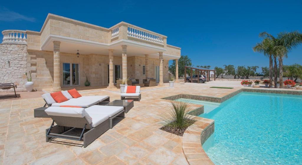 a villa with a swimming pool and a house at Villa Merlata in Ostuni