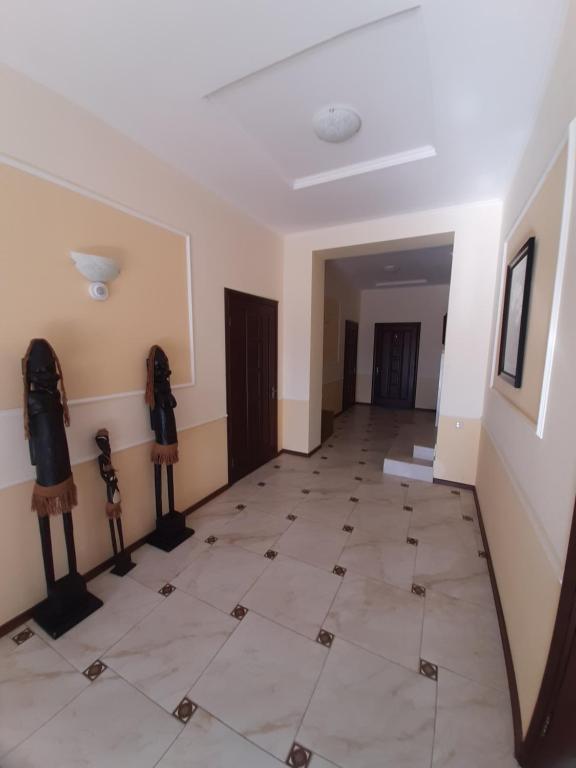 a hallway with a tiled floor and a room at Гостевой дом in Chornomorsk