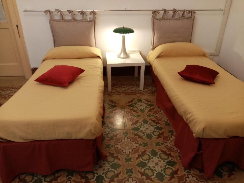 two beds sitting next to each other in a room at Guesthouse City Center in Bari