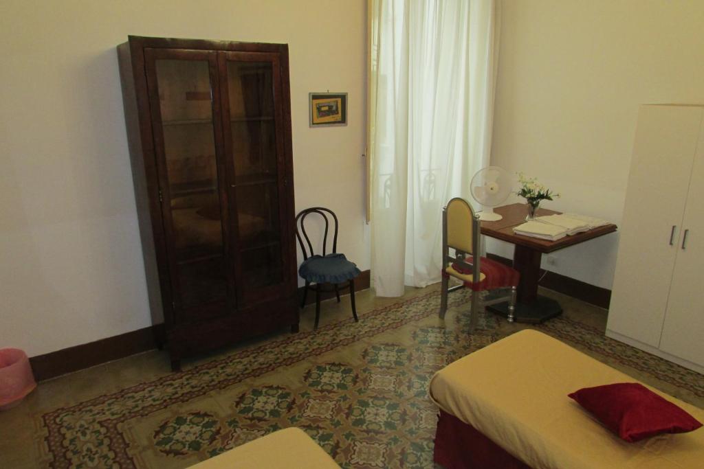 a room with a bedroom with a table and a tableablish at Guesthouse City Center in Bari