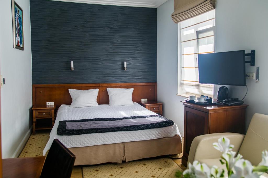 Postel nebo postele na pokoji v ubytování Hotel Apollo