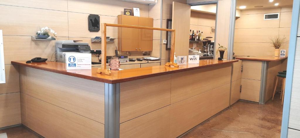 a kitchen with a counter with a coffee maker on it at Hotel Urogallo in Vielha