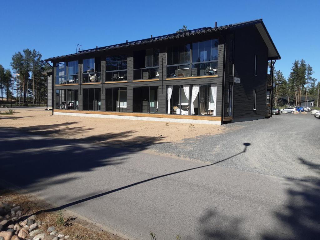 a large black building with a lot of windows at Kalajoen Hiekkasärkät Auringonsäde A1 in Kalajoki