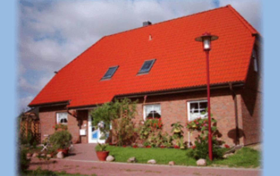 a red roofed house with a red roof at Haus Moewennest in Gelting