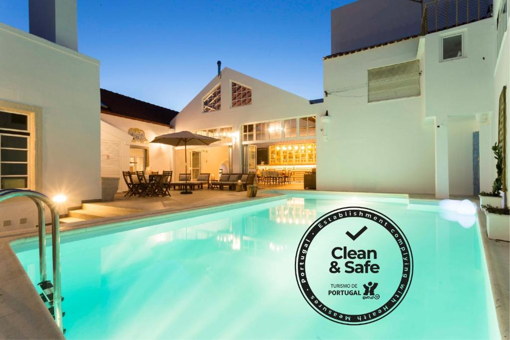 a hotel room with a pool and a swimming pool at Ericeira Soul Guesthouse in Ericeira
