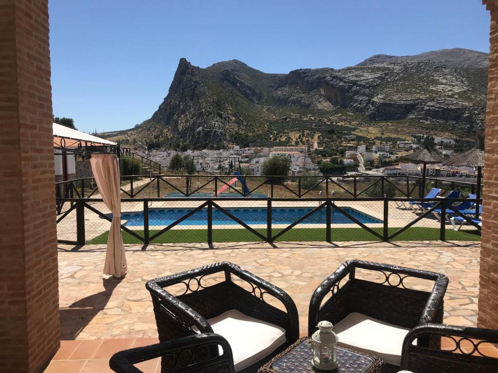 a patio with a view of a pool and mountains at Mayte Dreams Caminito Del Rey in Valle de Abdalagís