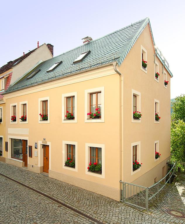 a large building with flower boxes on the windows at Ferienwohnung Königstein in Bad Schandau