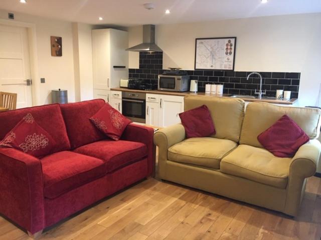 a living room with two couches and a kitchen at The Annexe - Acomb Green in York