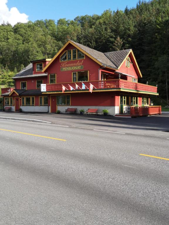 a red building on the side of a road at Kvamsdal Pensjonat in Eidfjord