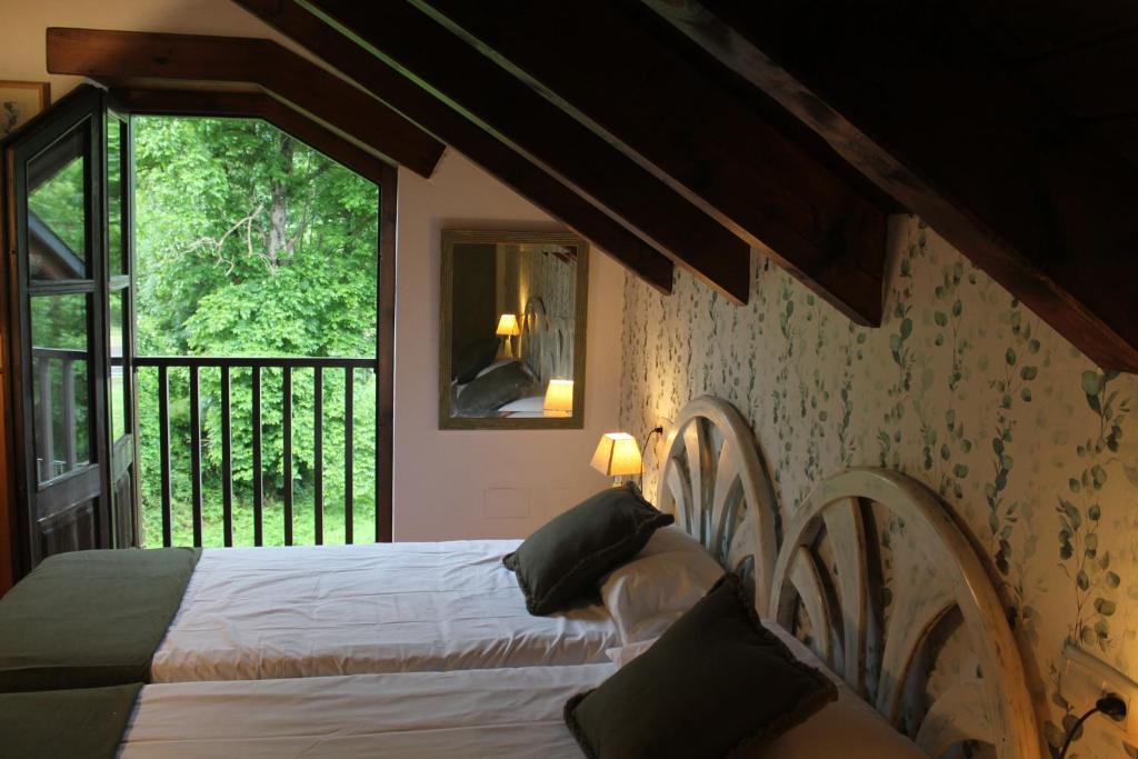 Postel nebo postele na pokoji v ubytování Hostal Casa Rosita