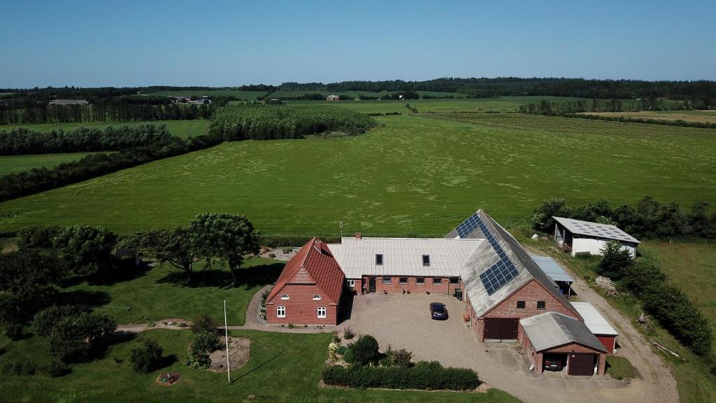 an aerial view of a large barn in a field at Hennebjerg overnatning in Stavsø