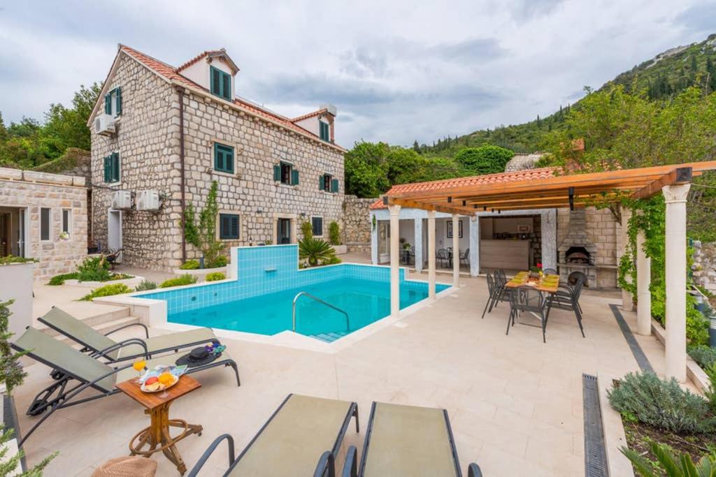 a patio with a swimming pool and a house at Villa Sarah in Lopud Island