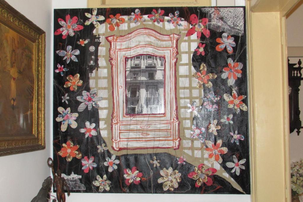 a quilt hanging on a wall with a window at Guesthouse City Center in Bari