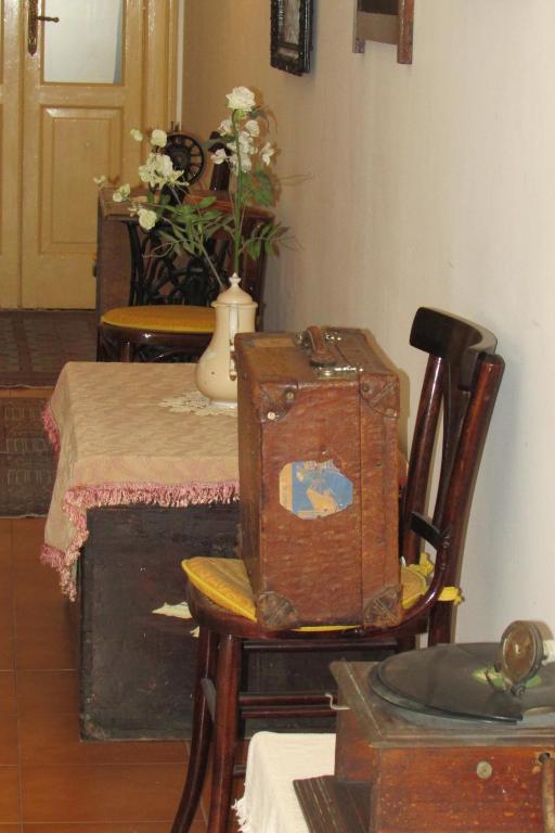 a room with a table and a chair with a suitcase at Guesthouse City Center in Bari
