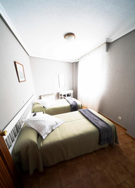 Cama o camas de una habitación en Hotel Isabel