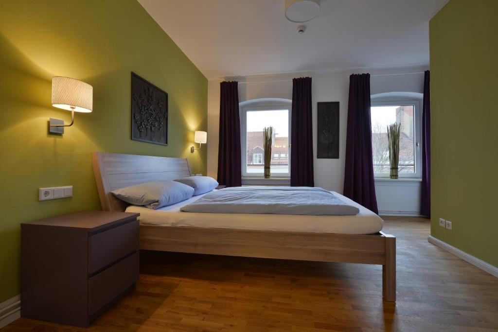 
a bedroom with a bed and a dresser at Townside Hostel Bremen in Bremen
