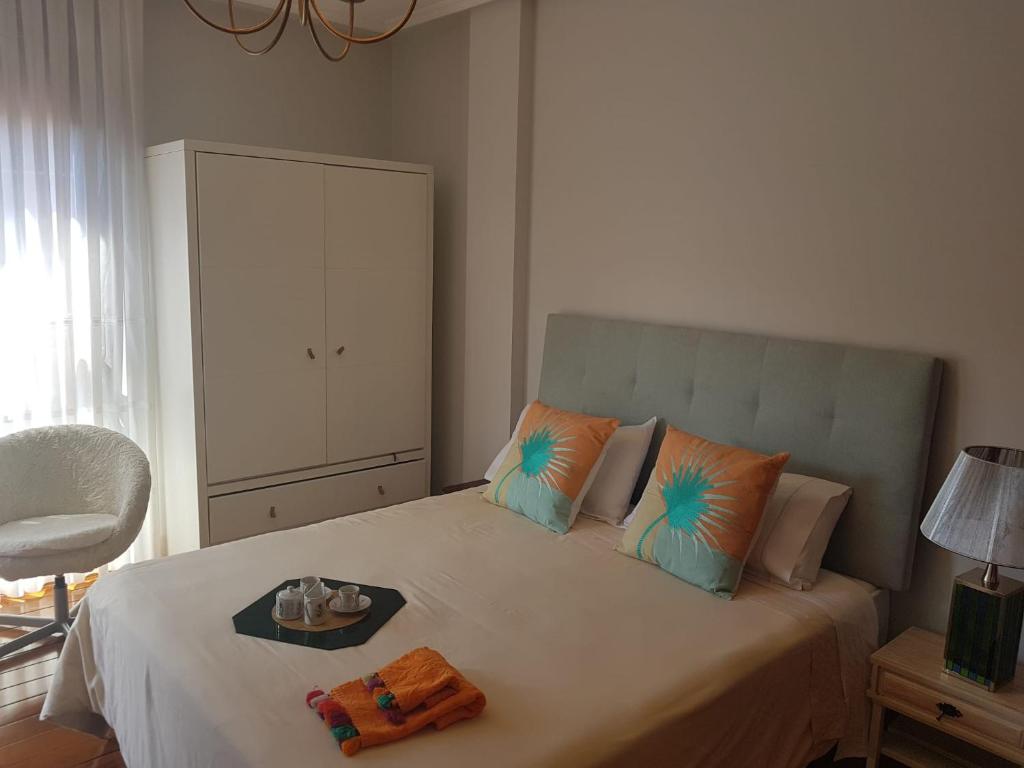 ein Schlafzimmer mit einem Bett und einem Tablett darauf in der Unterkunft Apartamento en la playa con parking privado in Getxo
