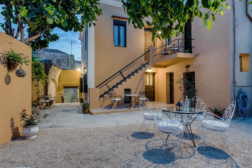 a patio with a table and chairs in a courtyard at Kristina´s Apartments in Rhodes Town