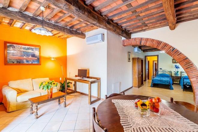 a living room with a couch and a table at Agriturismo Settepassi Tuscany in Ponte Buggianese