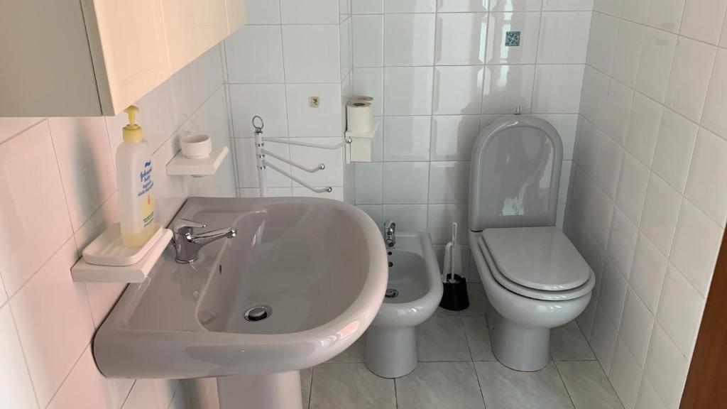 un bagno bianco con lavandino e WC di RESIDENZA CASA CLARY - SAMPEYRE - Bilocale Margherita a Sampeyre