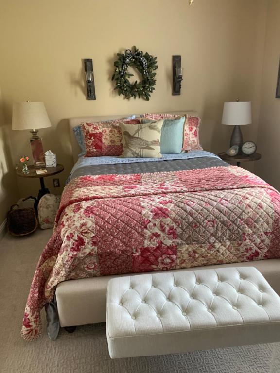 a bedroom with a large bed with a white bench at Yahweh House in Redding