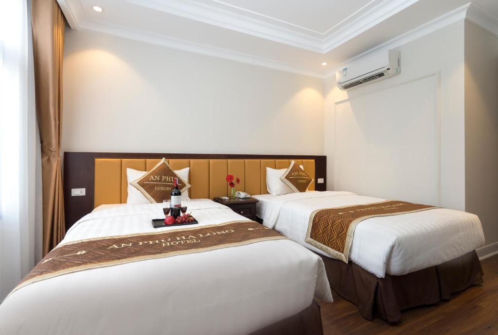 Postel nebo postele na pokoji v ubytování An Phu Ha Long Villa