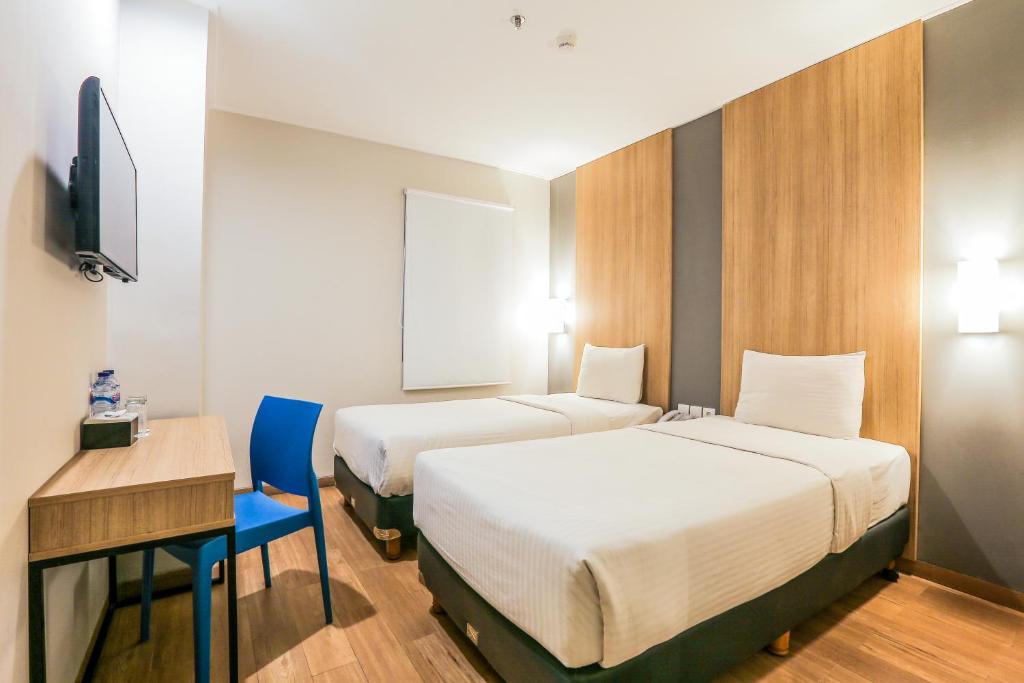 Postel nebo postele na pokoji v ubytování Hotel Citradream Bandung